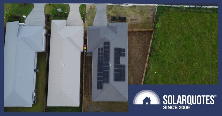 A rooftop with solar next to rooftops without solar